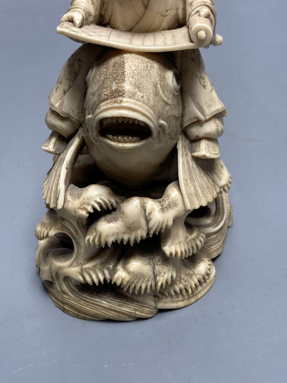 A fine Japanese ivory okimono of kinko riding a carp, 19th century, signed Ichyosen Naohide, height 15cm